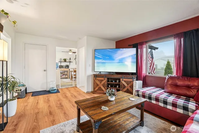 a living room with furniture a rug and a large window