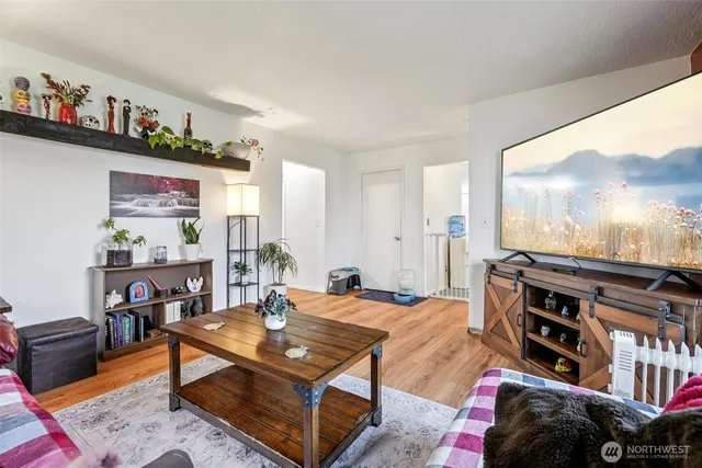 a bedroom with two beds and a painting on the wall