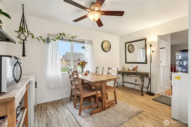 a kitchen with a refrigerator a stove top oven a counter space and wooden floor