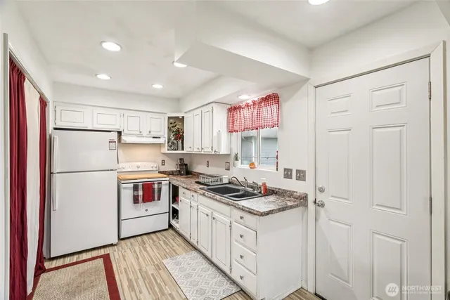 a kitchen with a stove a sink and a refrigerator