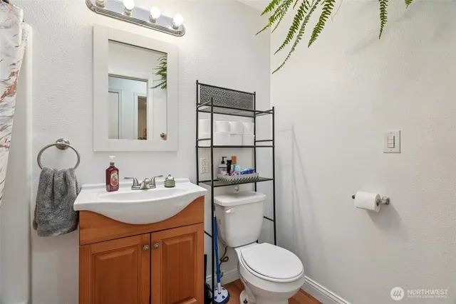 a bedroom with a bed window and a flat tv screen