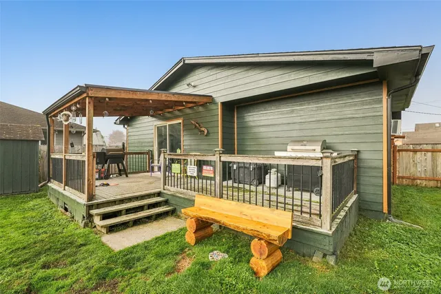 a view of a house with a yard and sitting area