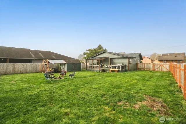 a view of a house with backyard sitting area and garden