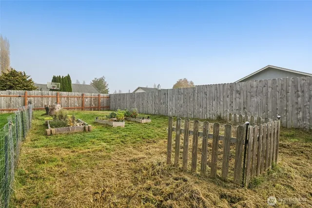 a view of a house with backyard sitting area and garden