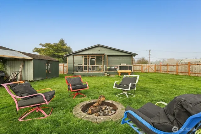 a view of a chairs in backyard of house