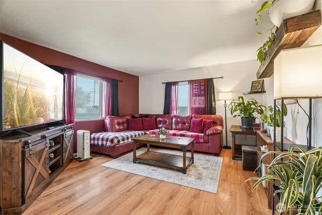 a living room with furniture and wooden floor
