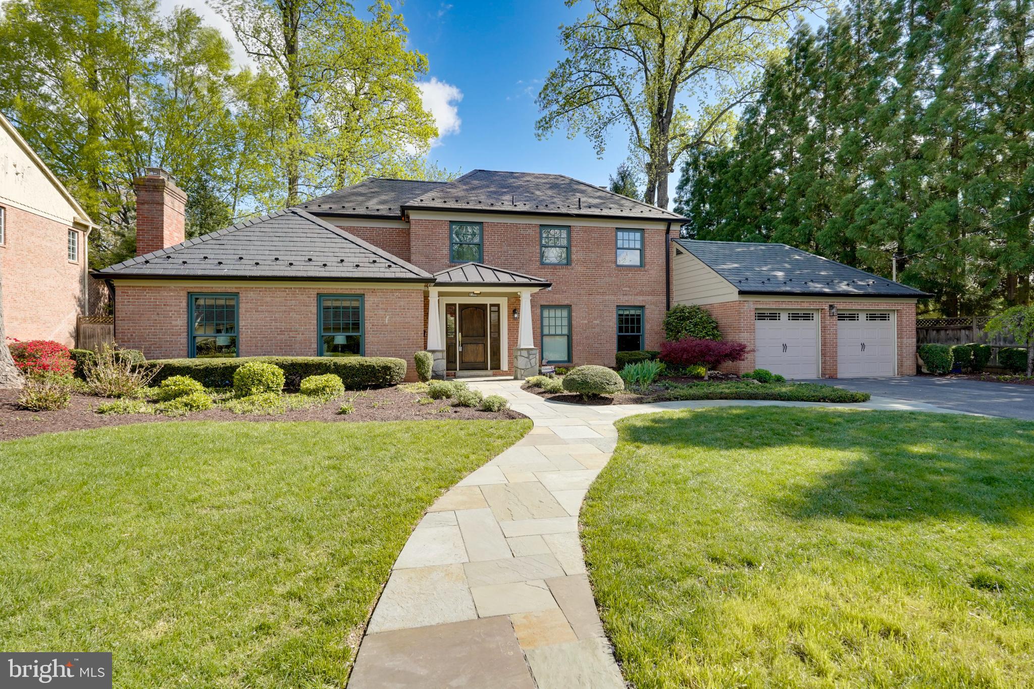 a front view of a house with yard patio and green space