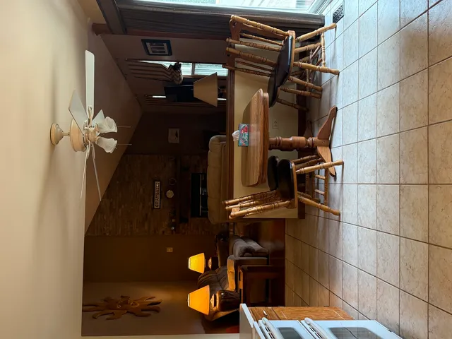 a kitchen with a table chairs refrigerator and cabinets