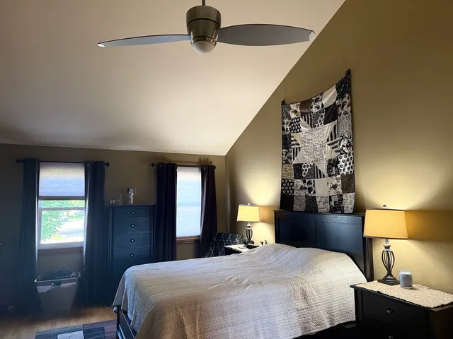 a bedroom with a bed and a night stand