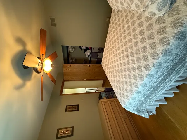 a bedroom with a bed and a chandelier