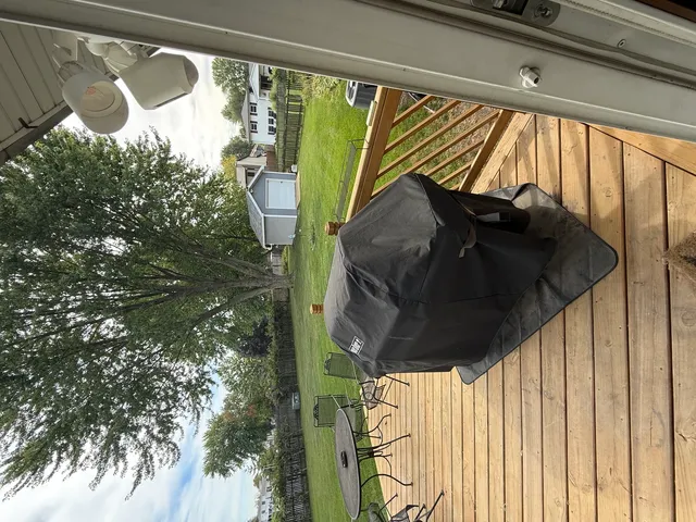 a couple of table and chairs in backyard of house