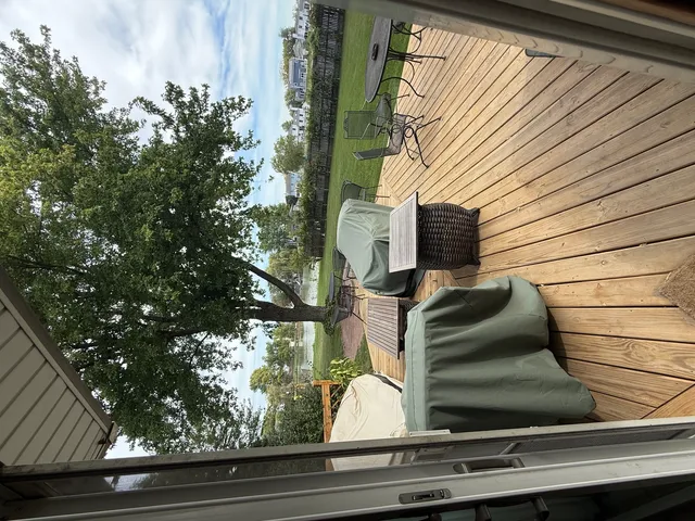 a front view of a house with a yard fire pit and trees
