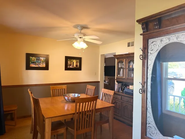 a view of a dining room with furniture and window
