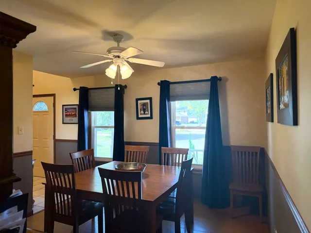 a dining room with furniture and window