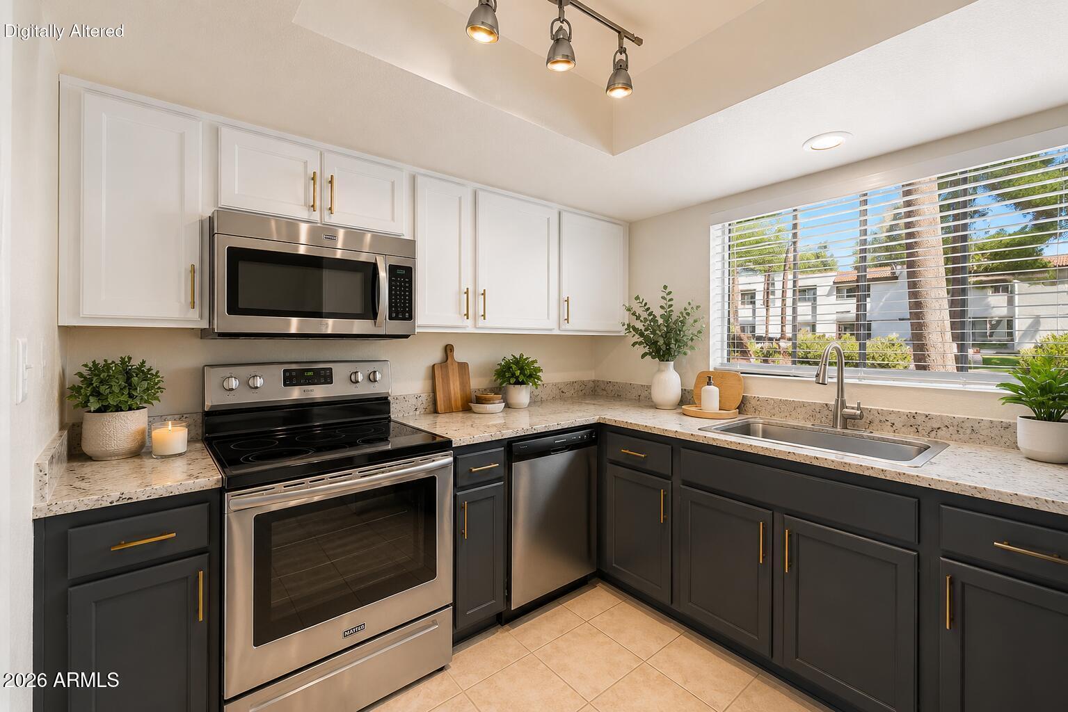 6885 East Cochise Road, Unit 142 Paradise Valley, AZ 85253 - Photo 7 of 47 a kitchen with sink a microwave and cabinets