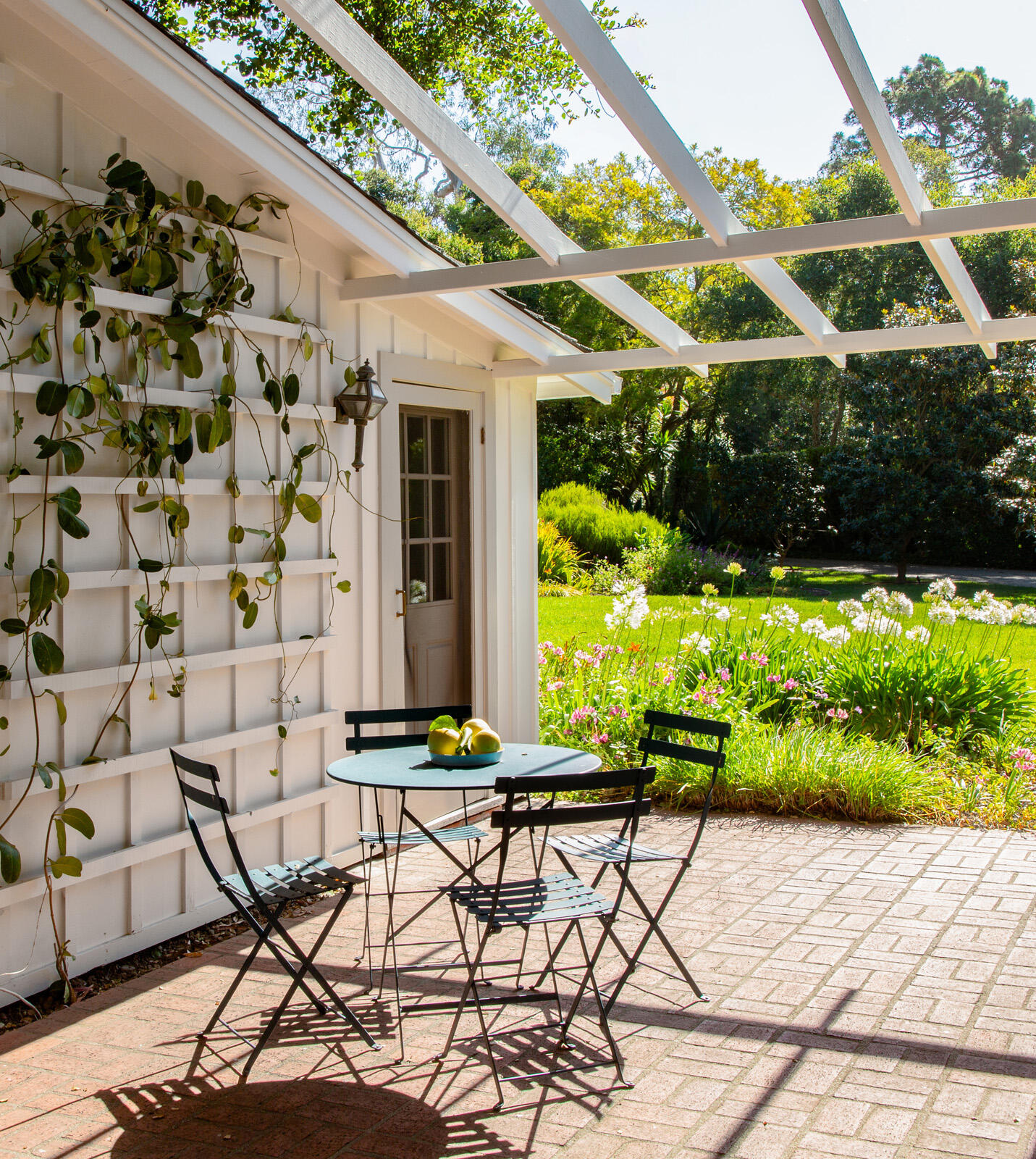 279 Santa Rosa Lane Montecito, CA 93108 - Photo 20 of 27 a front view of a house with a yard and potted plants