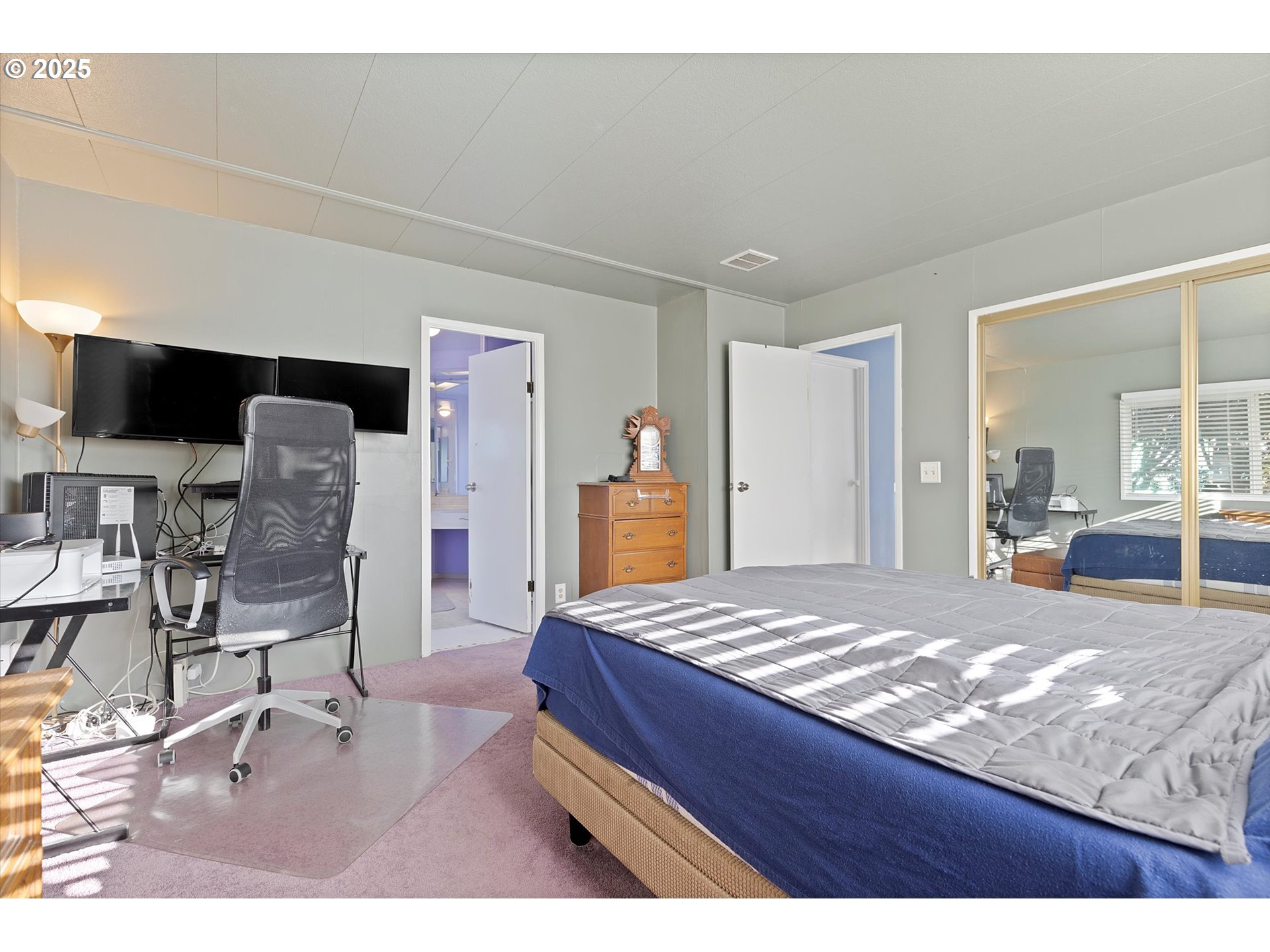 2901 East 2nd Street, Unit 84 Newberg, OR 97132 - Photo 14 of 30 a bedroom with a bed and view of living room