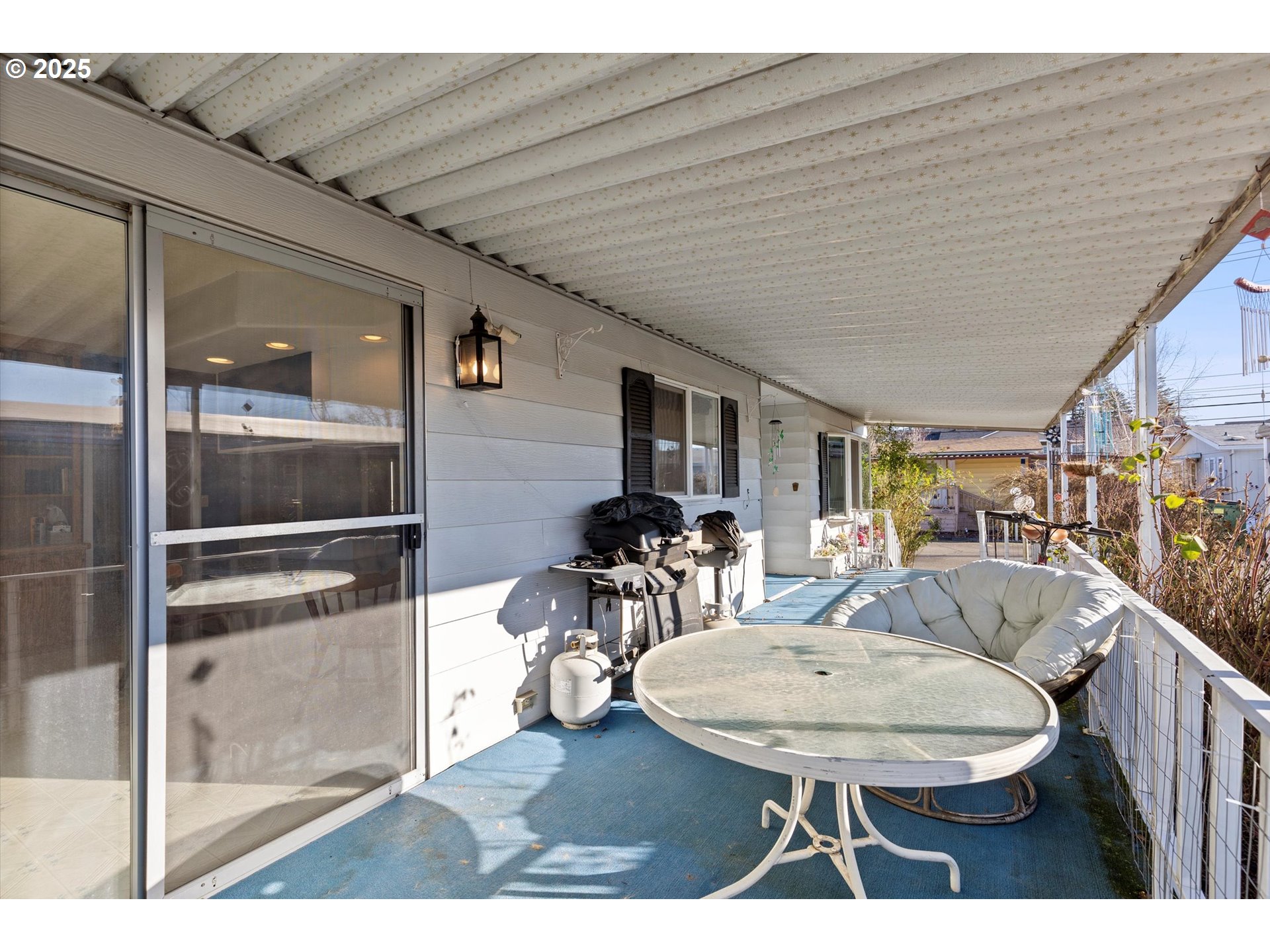 2901 East 2nd Street, Unit 84 Newberg, OR 97132 - Photo 26 of 30 a living room with furniture a flat screen tv and a table