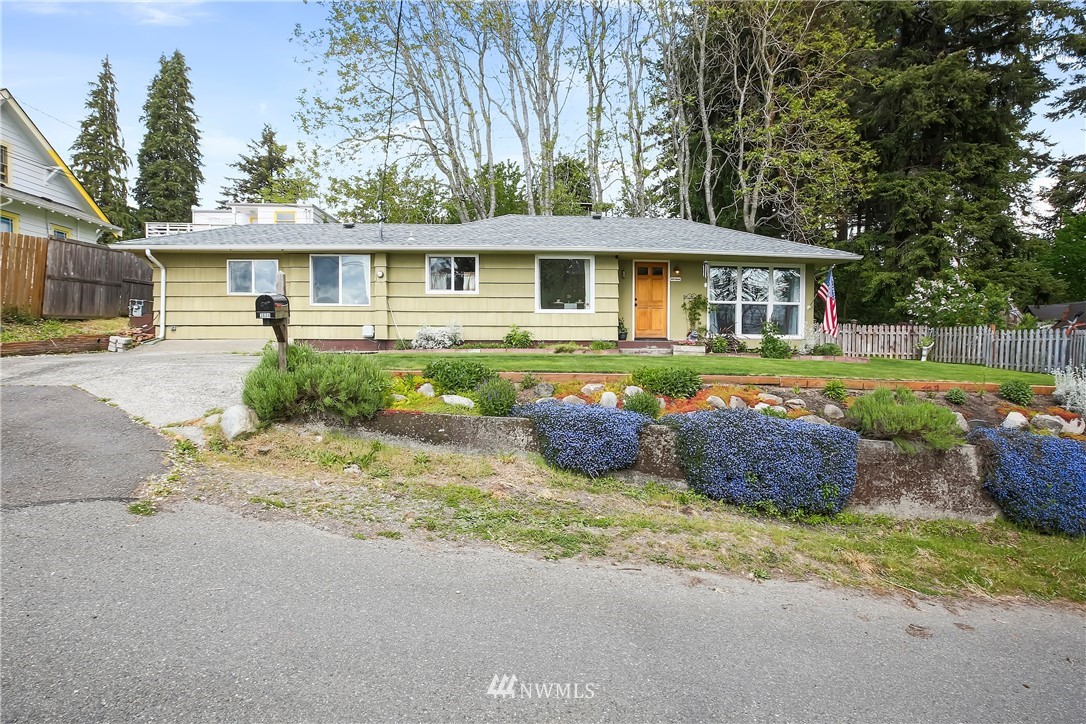 3604 Madrona Street Bremerton, WA 98312 - Photo 1 of 37 a front view of a house with a garden and porch