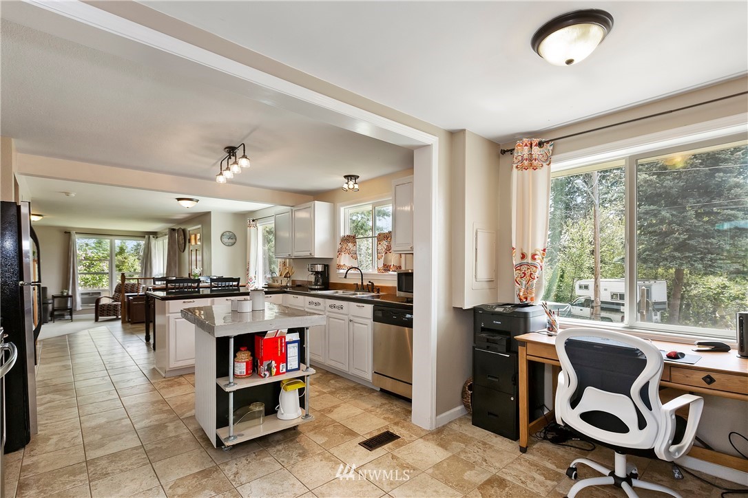 3604 Madrona Street Bremerton, WA 98312 - Photo 11 of 37 a living room with stainless steel appliances granite countertop furniture a rug and a view of kitchen