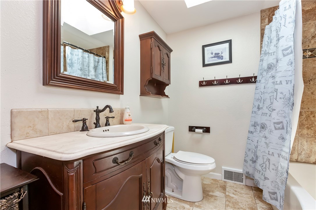 3604 Madrona Street Bremerton, WA 98312 - Photo 16 of 37 a bathroom with a toilet sink and mirror