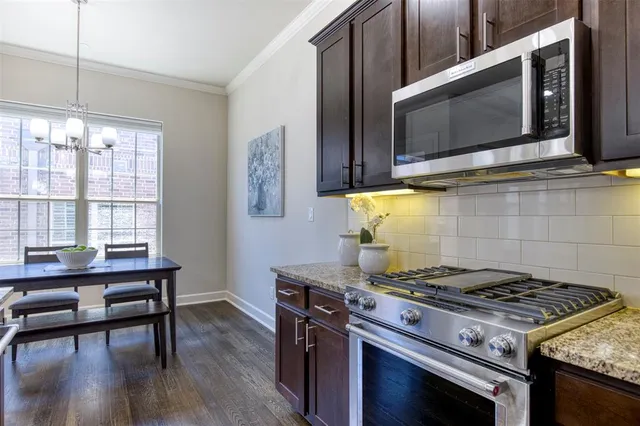 a stove top oven sitting inside of a kitchen