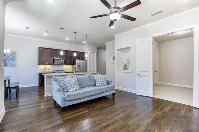a living room with furniture and kitchen view