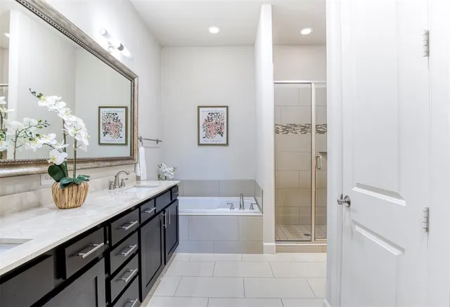 a bathroom with a granite countertop sink mirror and bathtub