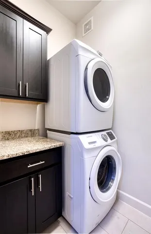 a utility room with sink dryer and washer