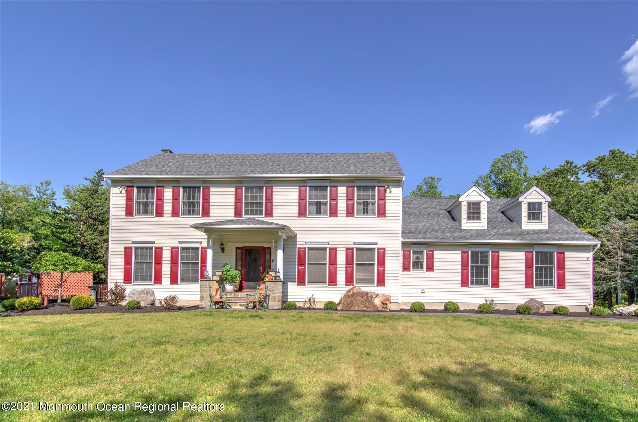 58 Brookside Road Millstone Township, NJ 08510 - Photo 1 of 34 a front view of a house with a garden and porch