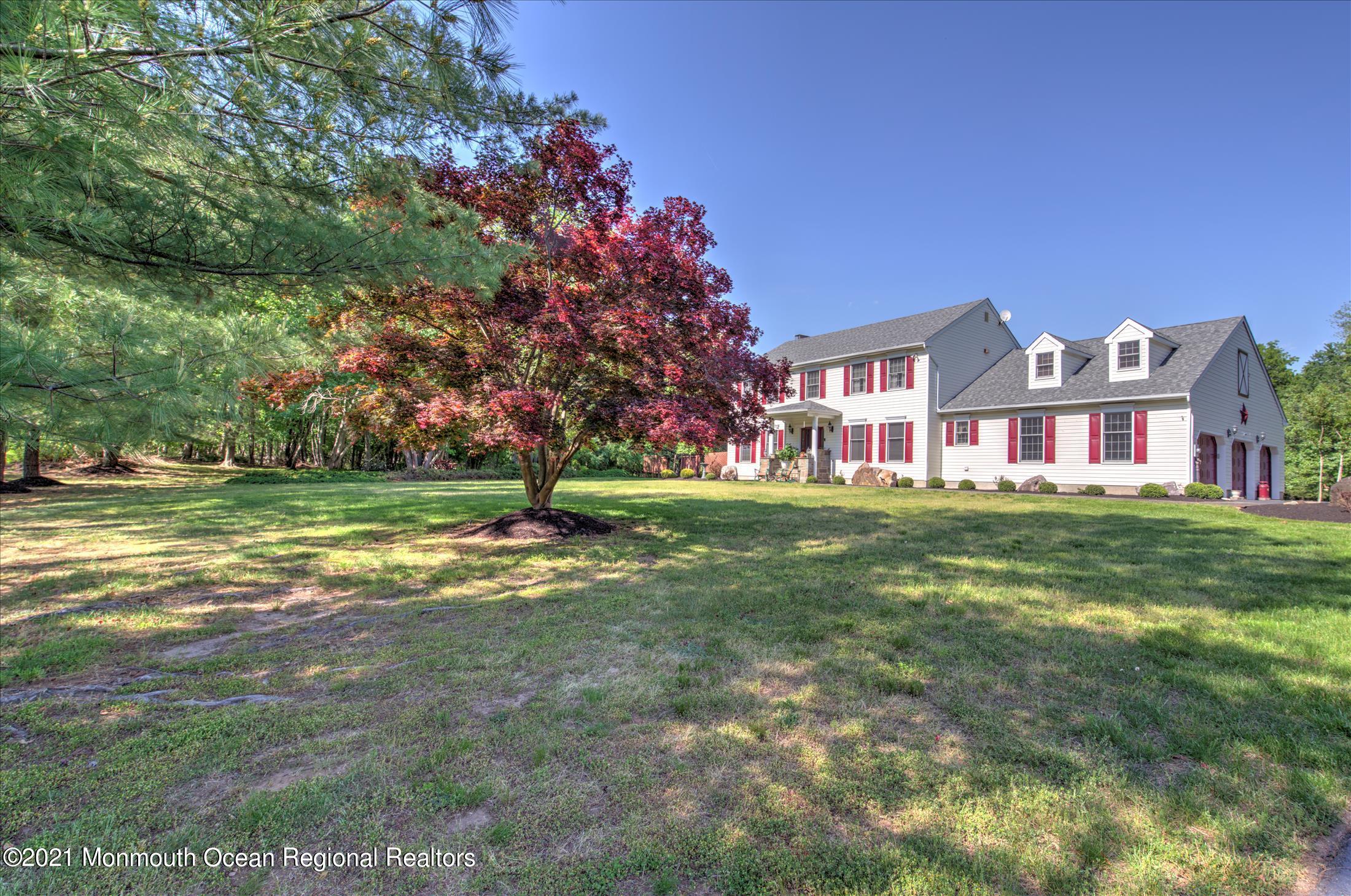 58 Brookside Road Millstone Township, NJ 08510 - Photo 2 of 34 a view of a big house with a big yard and large trees