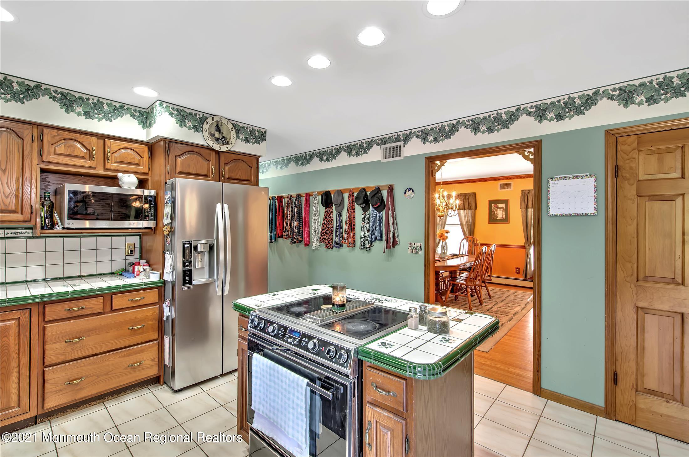 58 Brookside Road Millstone Township, NJ 08510 - Photo 13 of 34 a kitchen with stainless steel appliances granite countertop a stove a refrigerator and a stove top oven