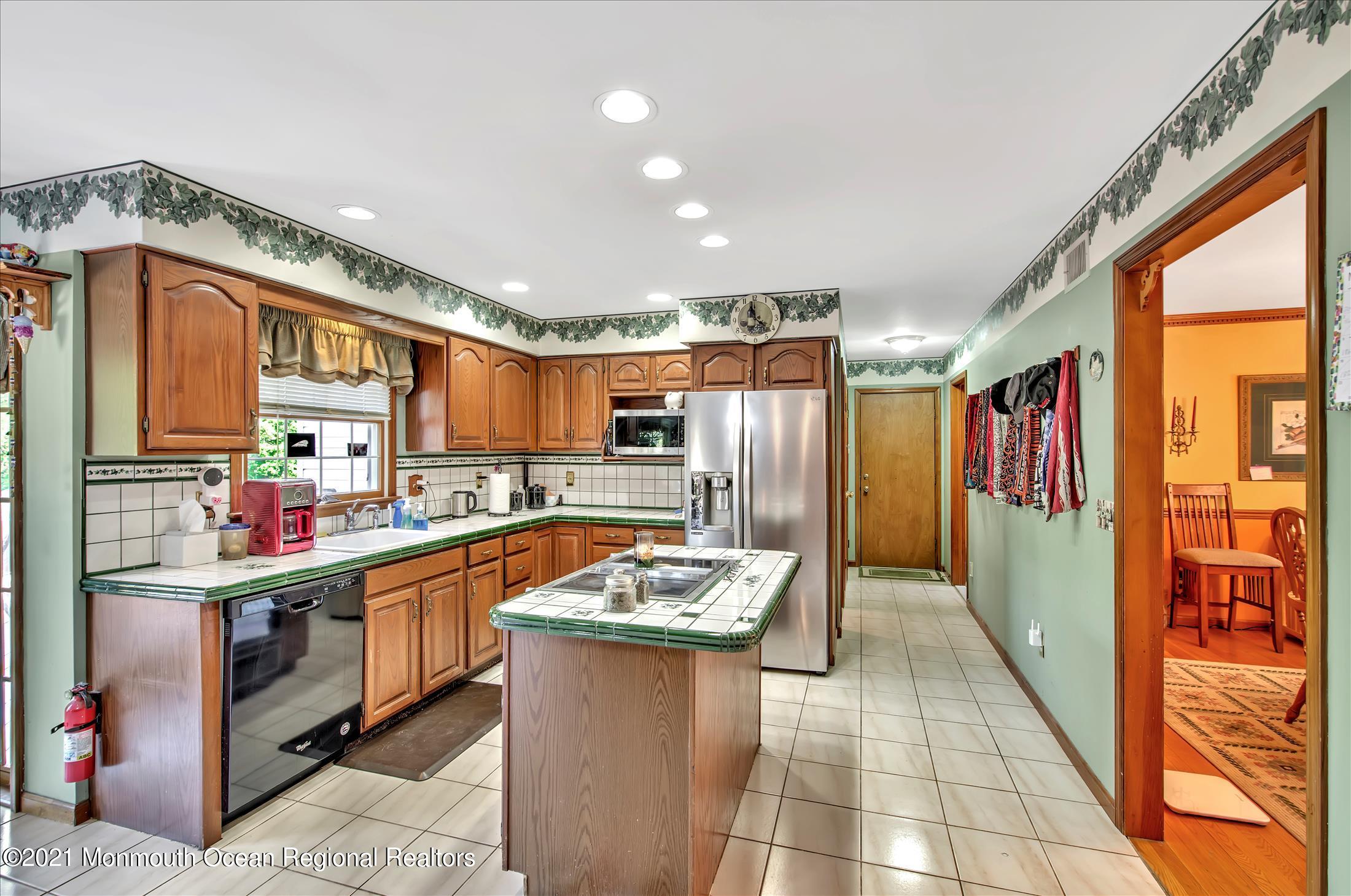58 Brookside Road Millstone Township, NJ 08510 - Photo 15 of 34 a kitchen with stainless steel appliances granite countertop a sink and a refrigerator