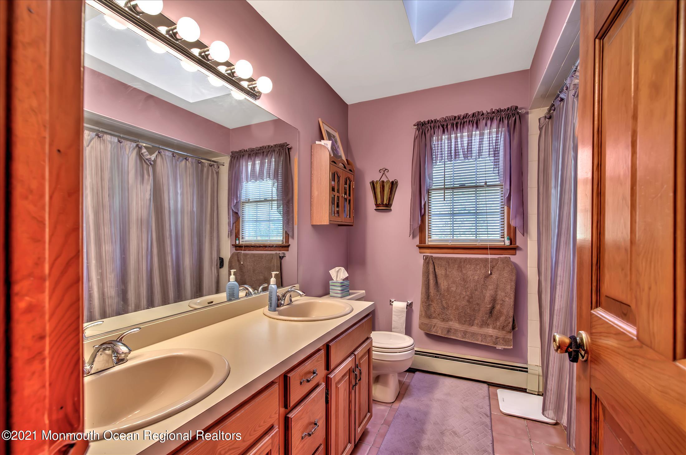 58 Brookside Road Millstone Township, NJ 08510 - Photo 16 of 34 a spacious bathroom with a sink a large mirror and a bathtub