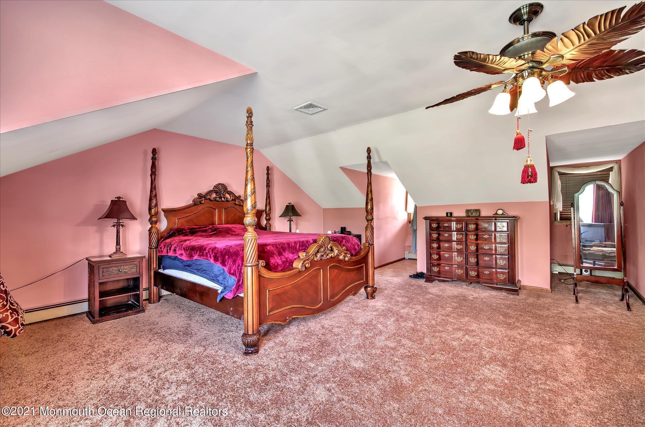 58 Brookside Road Millstone Township, NJ 08510 - Photo 17 of 34 a bedroom with bed and a chandelier