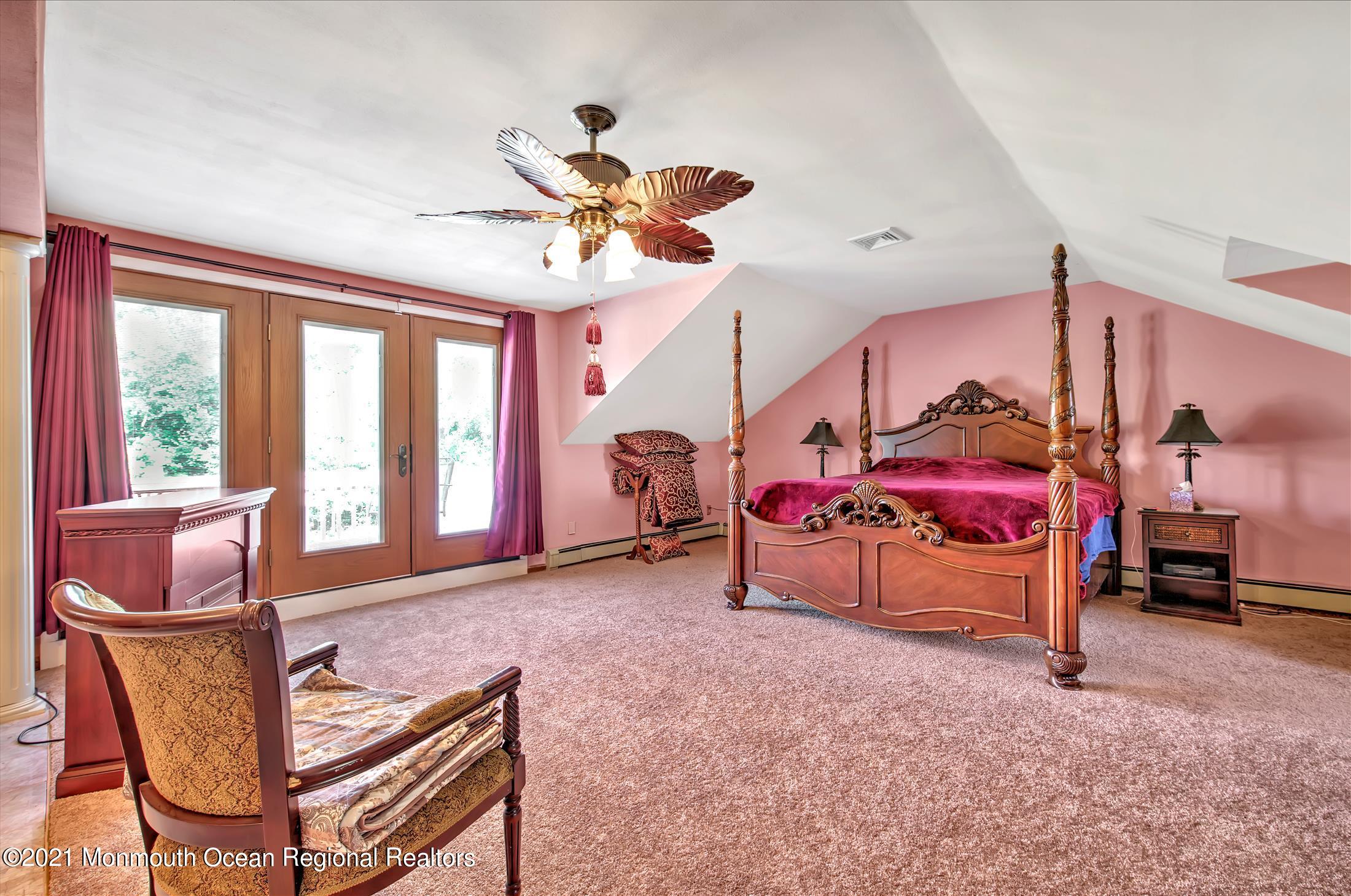 58 Brookside Road Millstone Township, NJ 08510 - Photo 19 of 34 a bedroom with furniture and a chandelier