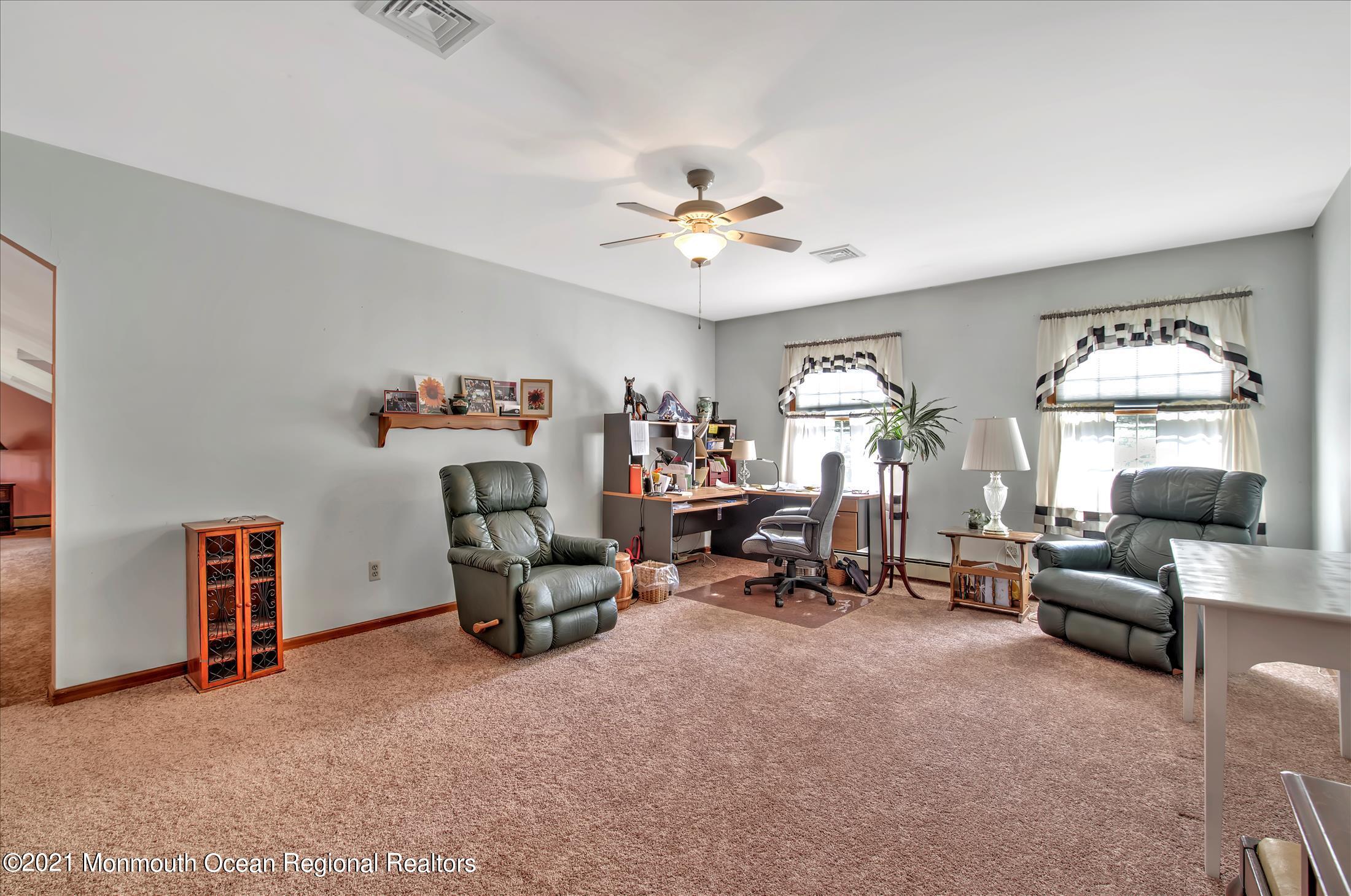 58 Brookside Road Millstone Township, NJ 08510 - Photo 20 of 34 a view of a livingroom with furniture and a ceiling fan