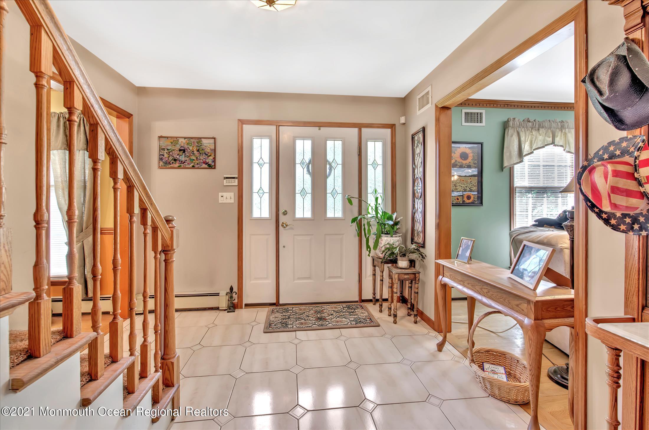 58 Brookside Road Millstone Township, NJ 08510 - Photo 3 of 34 a view of an entryway with wooden floor and windows