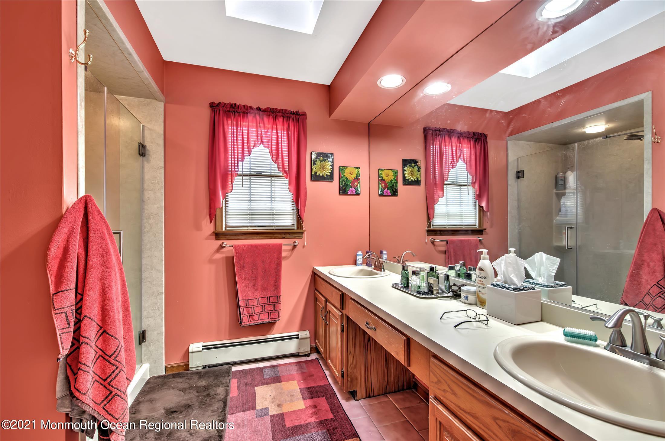 58 Brookside Road Millstone Township, NJ 08510 - Photo 22 of 34 a bathroom with a sink and a mirror