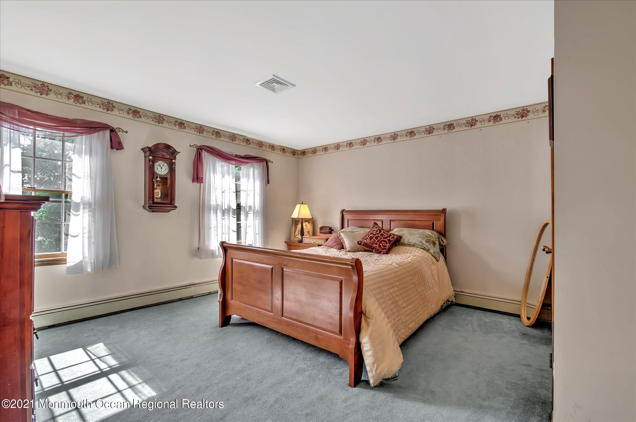 58 Brookside Road Millstone Township, NJ 08510 - Photo 25 of 34 a bed sitting in a bedroom next to a window
