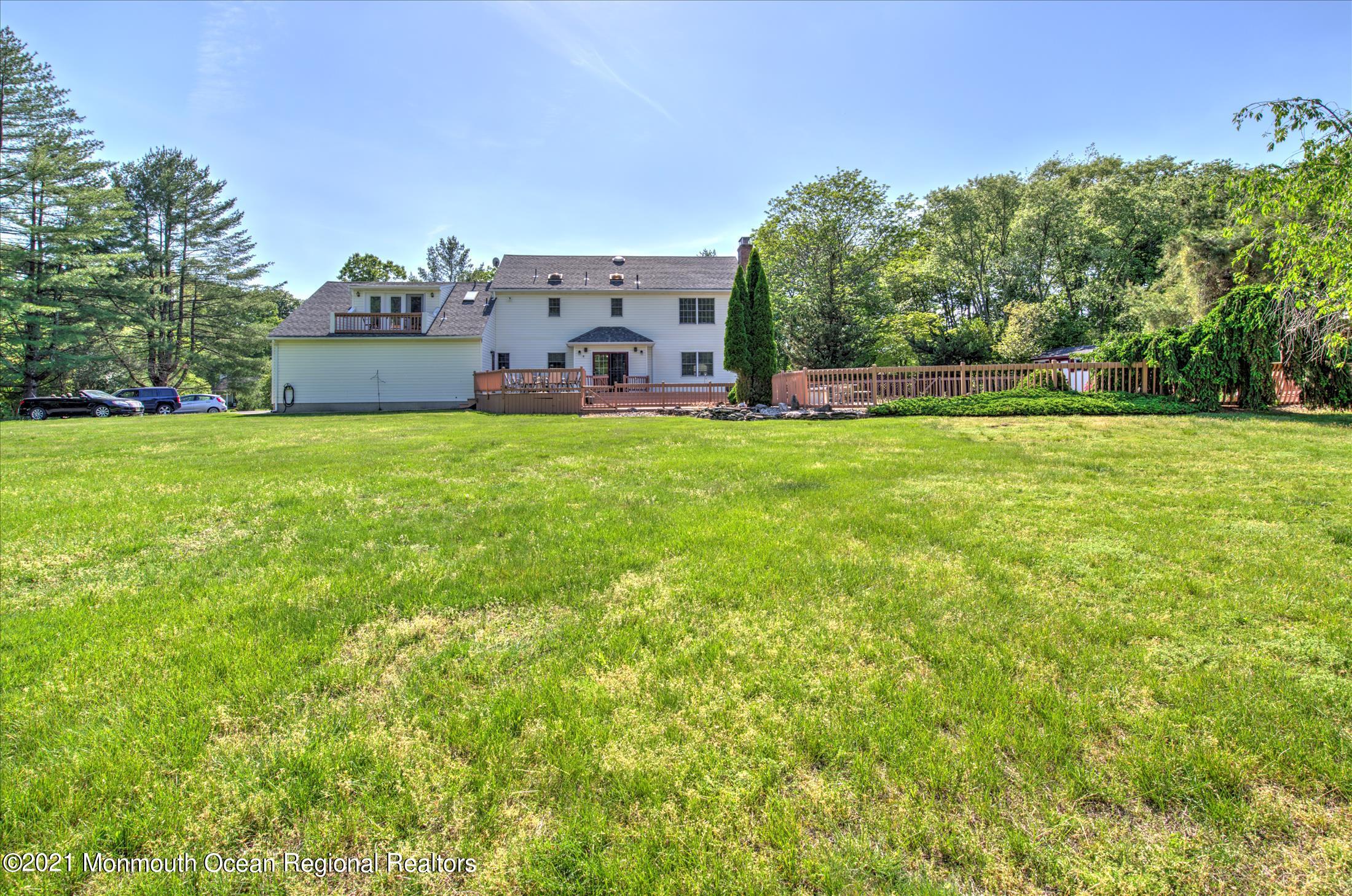 58 Brookside Road Millstone Township, NJ 08510 - Photo 28 of 34 a backyard of a house with plants and large trees