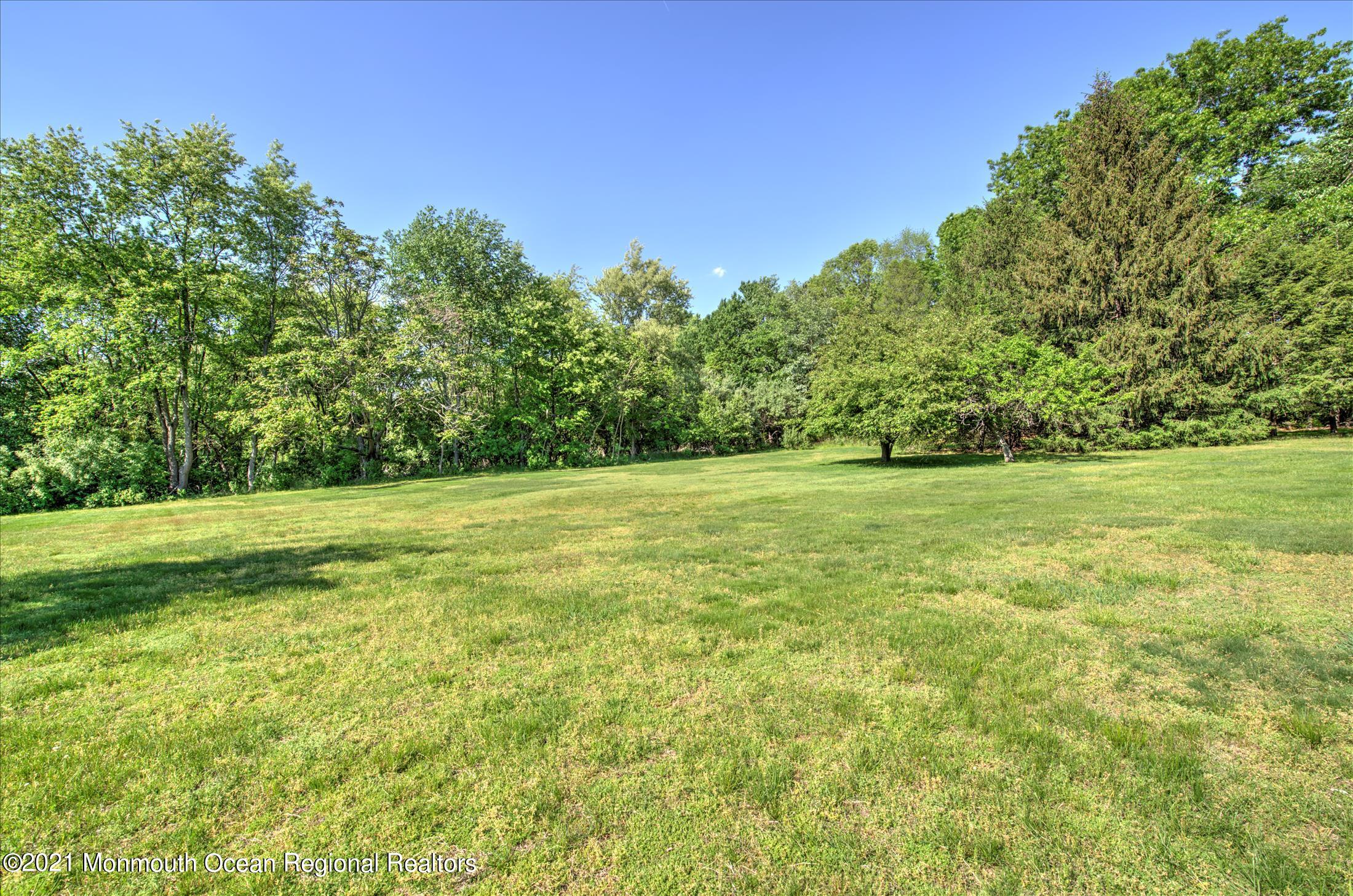 58 Brookside Road Millstone Township, NJ 08510 - Photo 29 of 34 a view of a green field with wooden fence