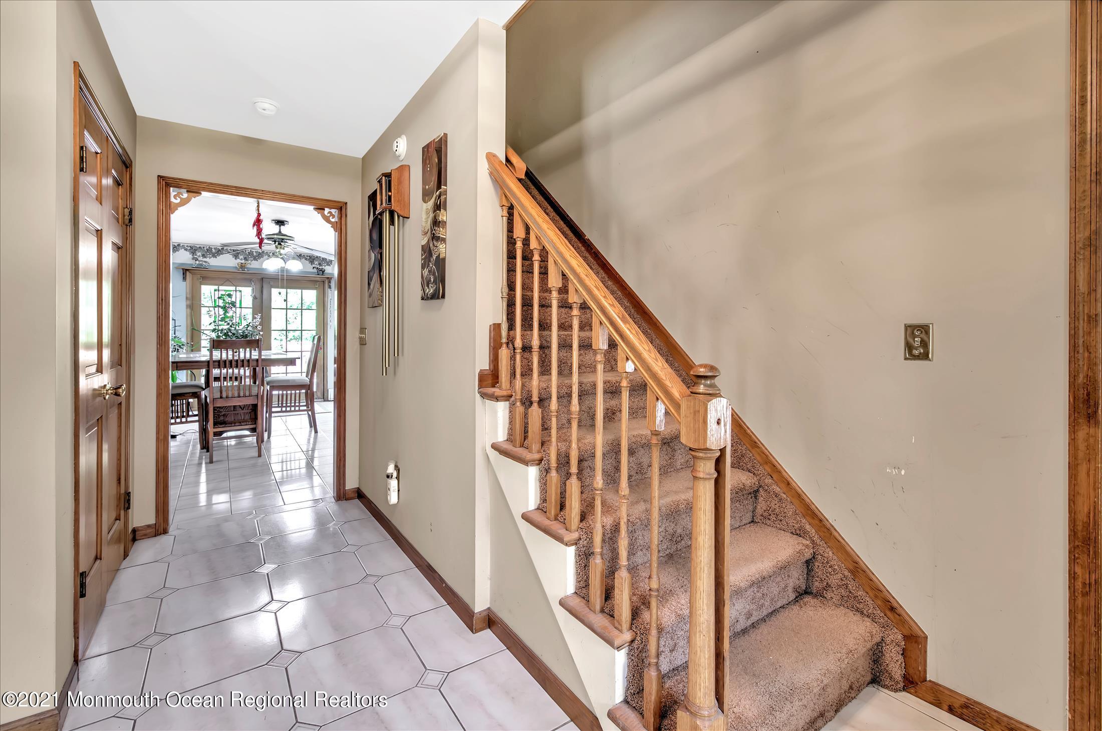 58 Brookside Road Millstone Township, NJ 08510 - Photo 4 of 34 a view of staircase with lots of frames on wall and a large window