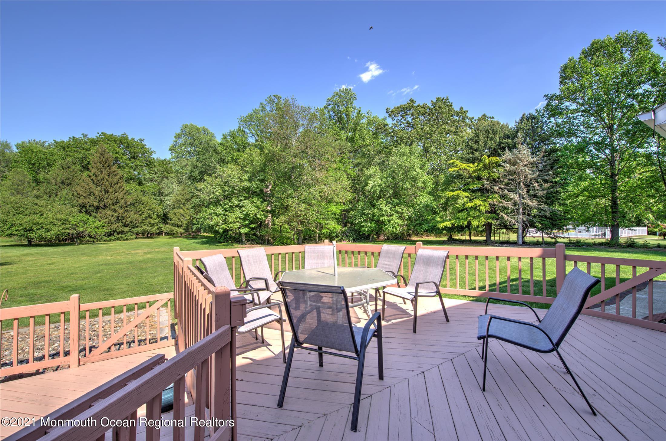 58 Brookside Road Millstone Township, NJ 08510 - Photo 31 of 34 a view of a chairs and table on the deck