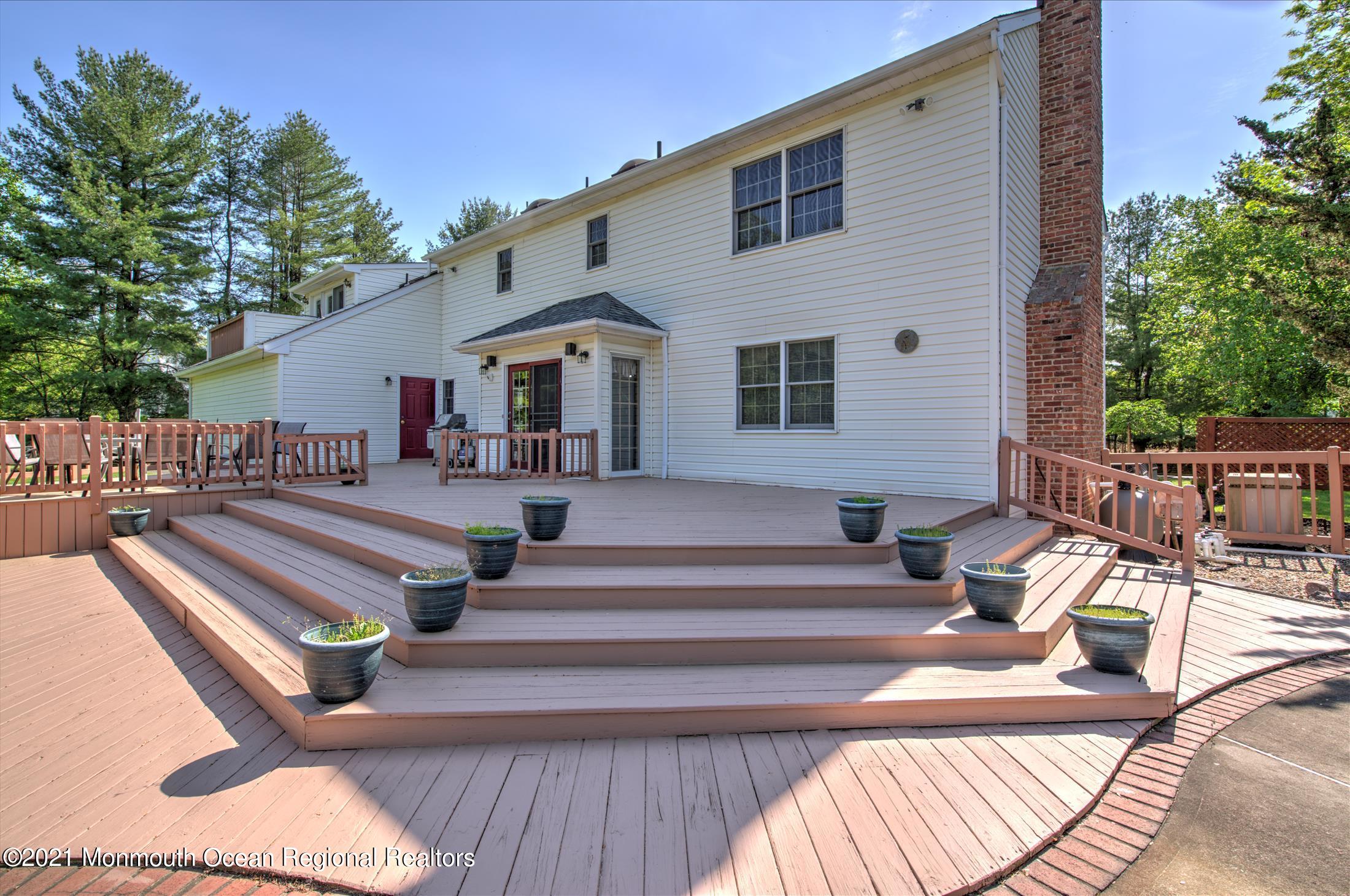 58 Brookside Road Millstone Township, NJ 08510 - Photo 32 of 34 a view of a patio with couches table and chairs and potted plants
