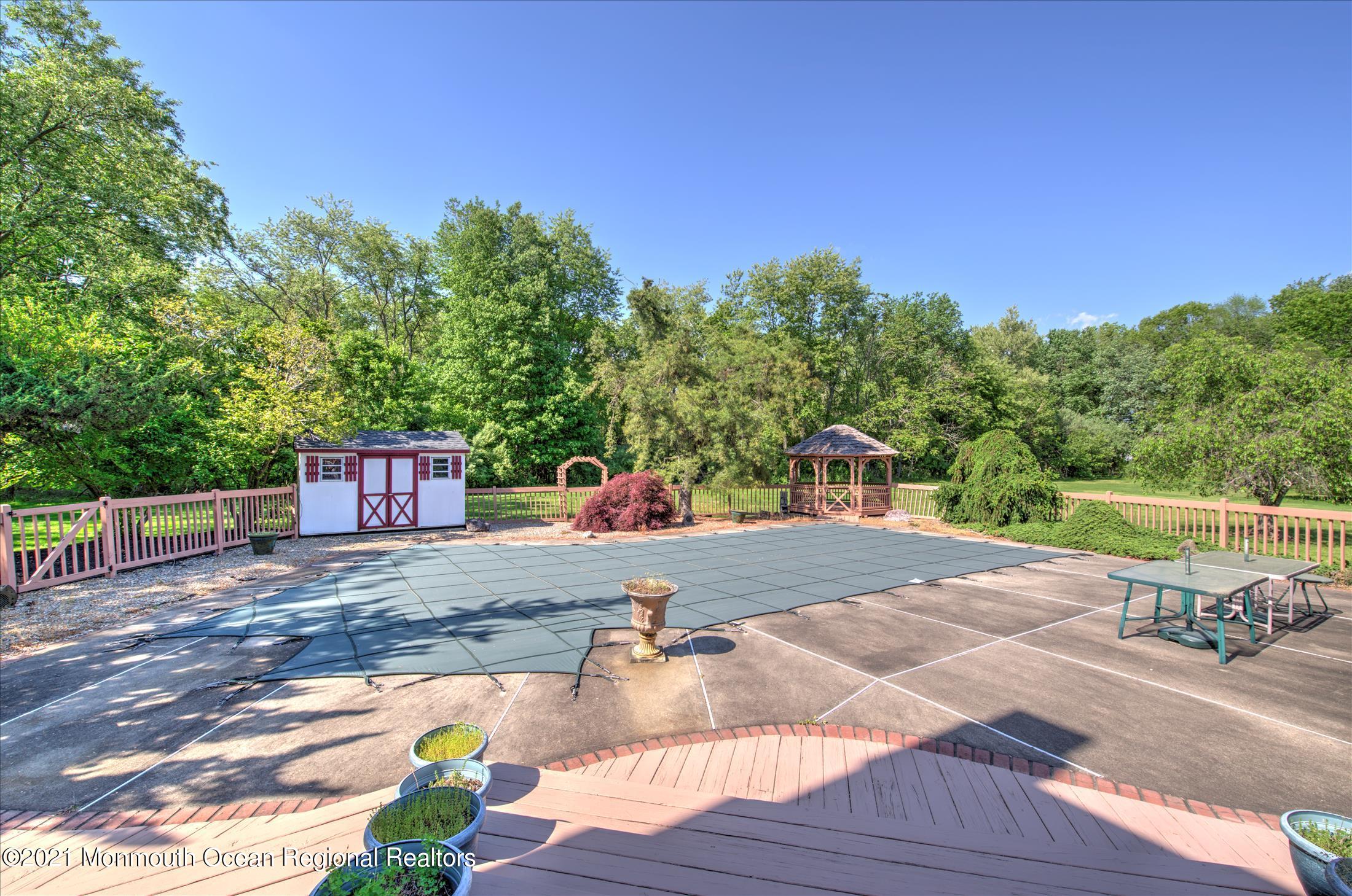 58 Brookside Road Millstone Township, NJ 08510 - Photo 33 of 34 a backyard of a house with table and chairs