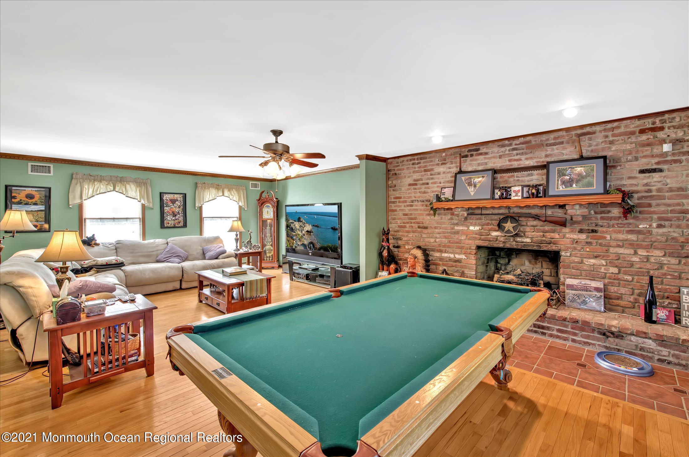 58 Brookside Road Millstone Township, NJ 08510 - Photo 5 of 34 a living room with furniture pool table and a fireplace