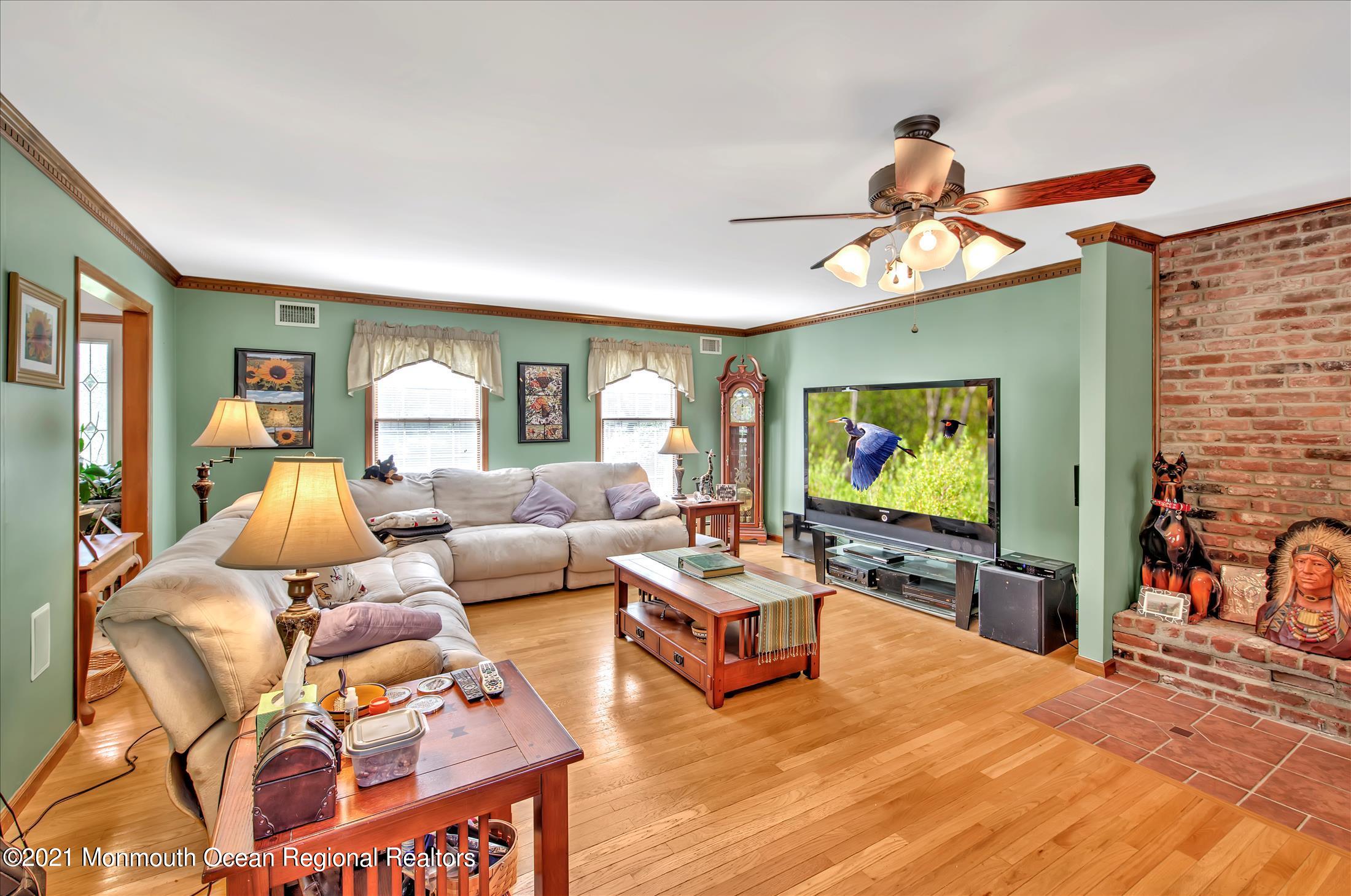 58 Brookside Road Millstone Township, NJ 08510 - Photo 8 of 34 a living room with furniture and a flat screen tv