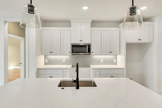 a kitchen with kitchen island a counter top space appliances and cabinets
