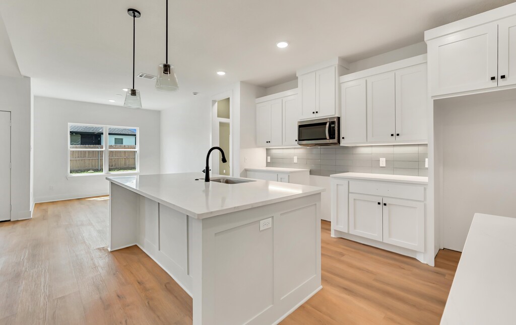 9904 Ridings Drive Waco, TX 76708 - Photo 12 of 37 a kitchen with a sink stove and microwave